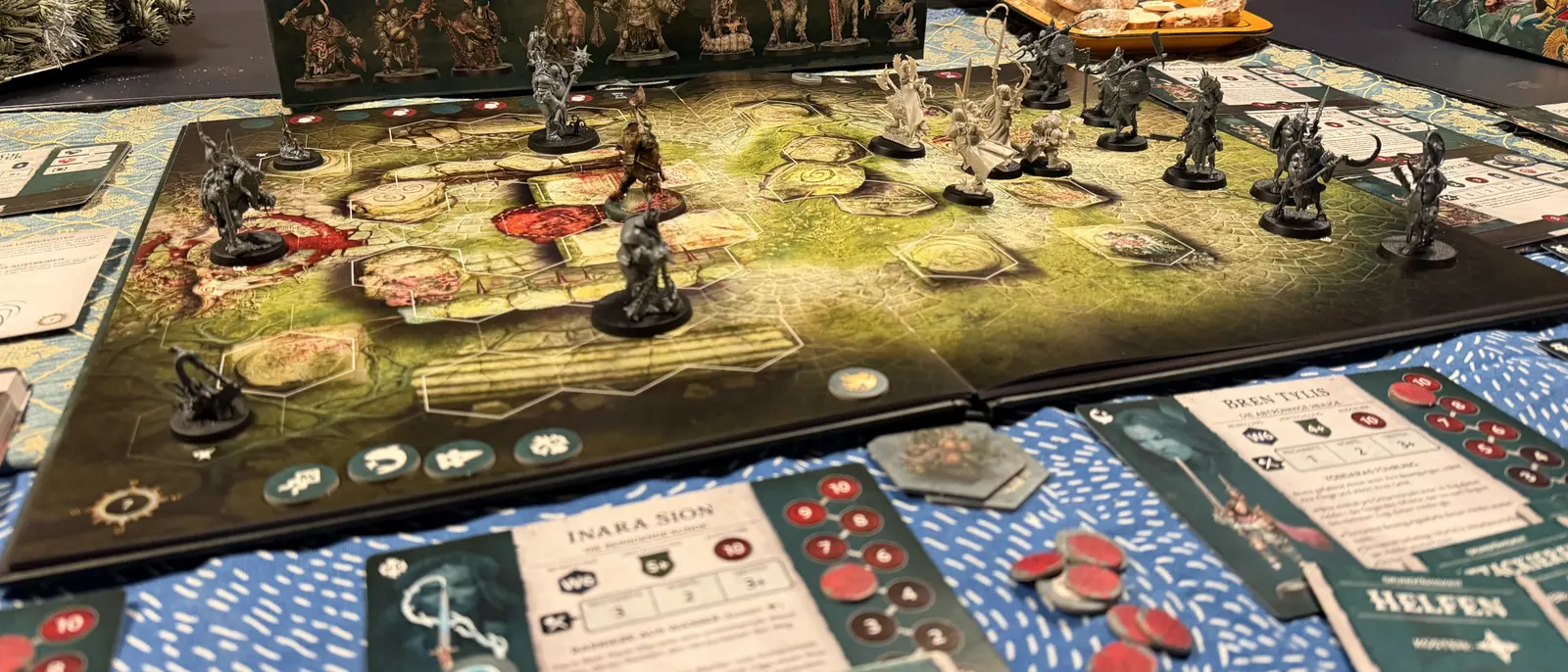 A miniatures board game in progress, painted heroes on the board